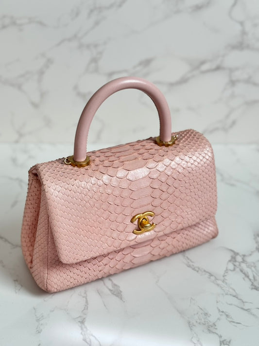 Chanel Top Handle Flap Bag crafted in pink python leather with gold-tone hardware